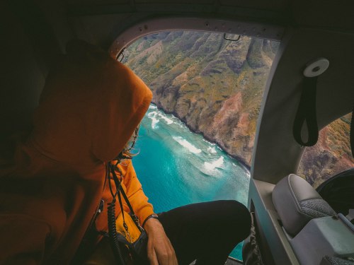 Person in plane looking out at sea