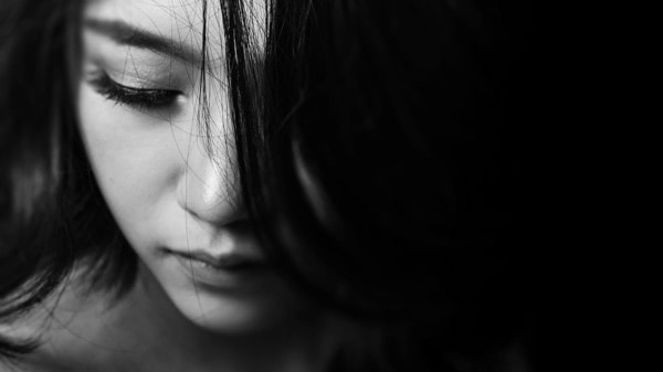 Woman looking down in black and white